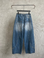 Light blue denim pants with wide-leg cut, belt loops, and back graphic print