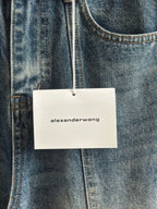 Blue denim pants with “alexanderwang” hang tag on belt loop
