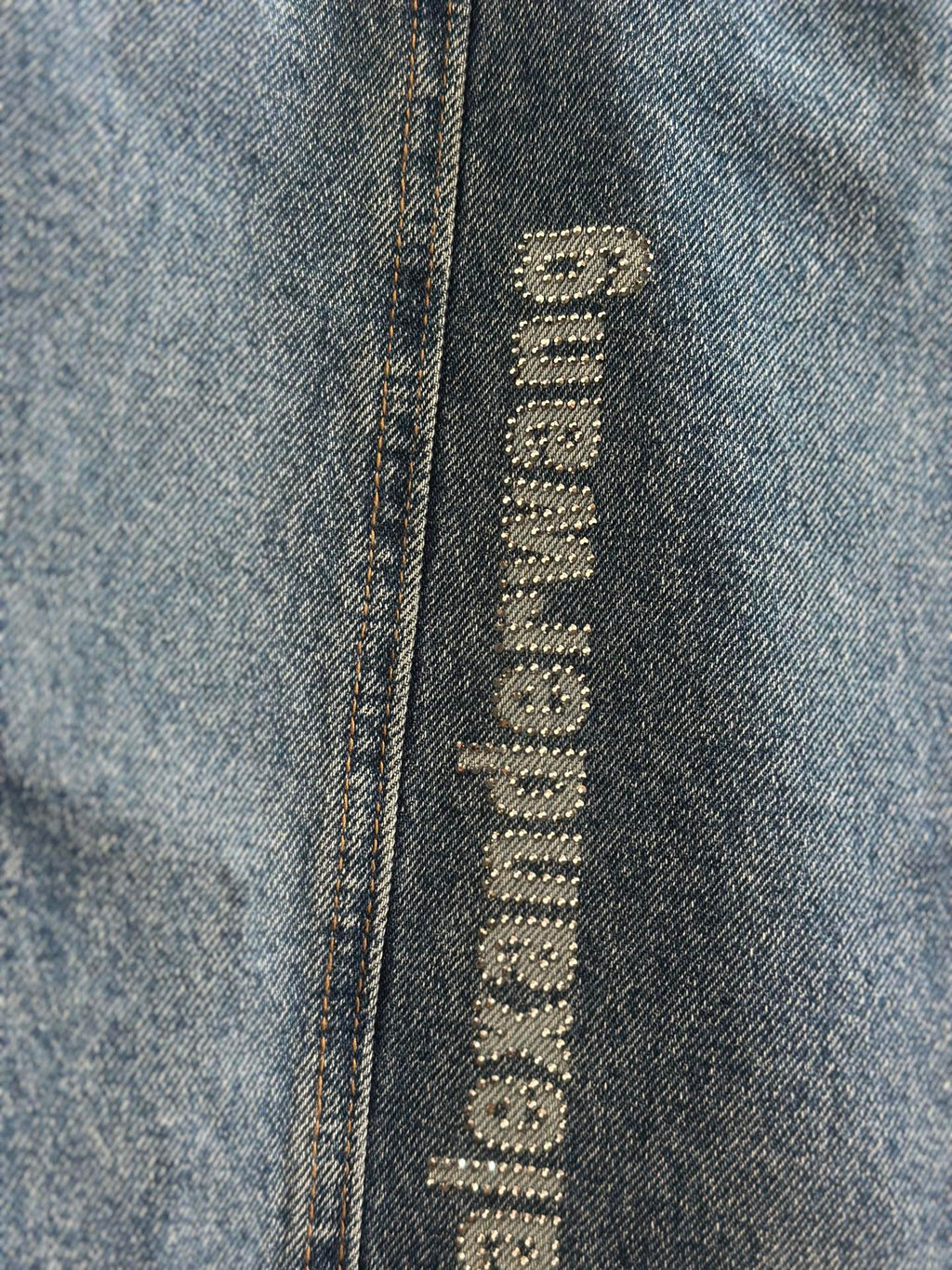 Blue denim pants with close-up vertical “alexanderwang” logo label