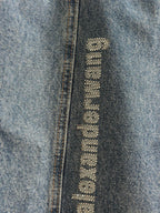 Blue denim pants with close-up vertical “alexanderwang” logo label