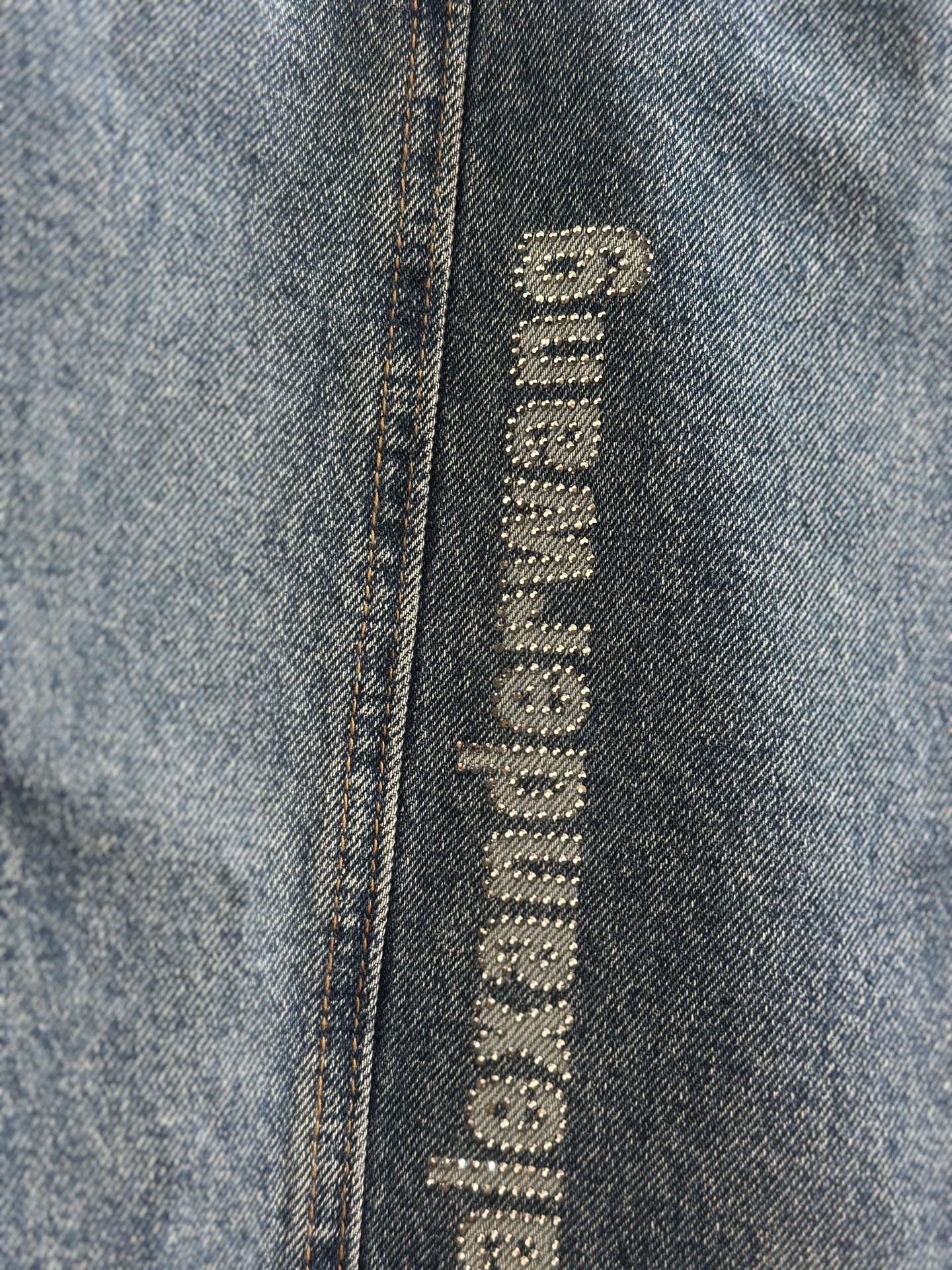 Blue denim pants with close-up vertical “alexanderwang” logo label