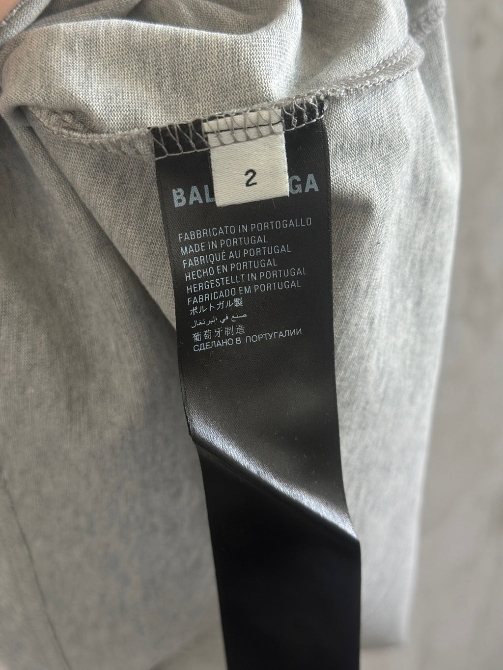Gray T-shirt neck tag with size 2 and Balenciaga branding