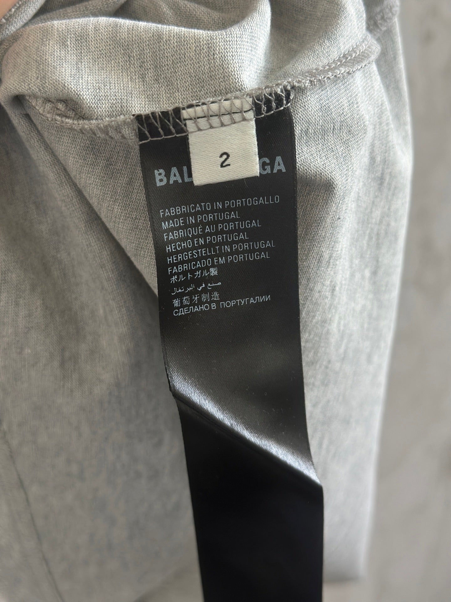 Gray T-shirt neck tag with size 2 and Balenciaga branding