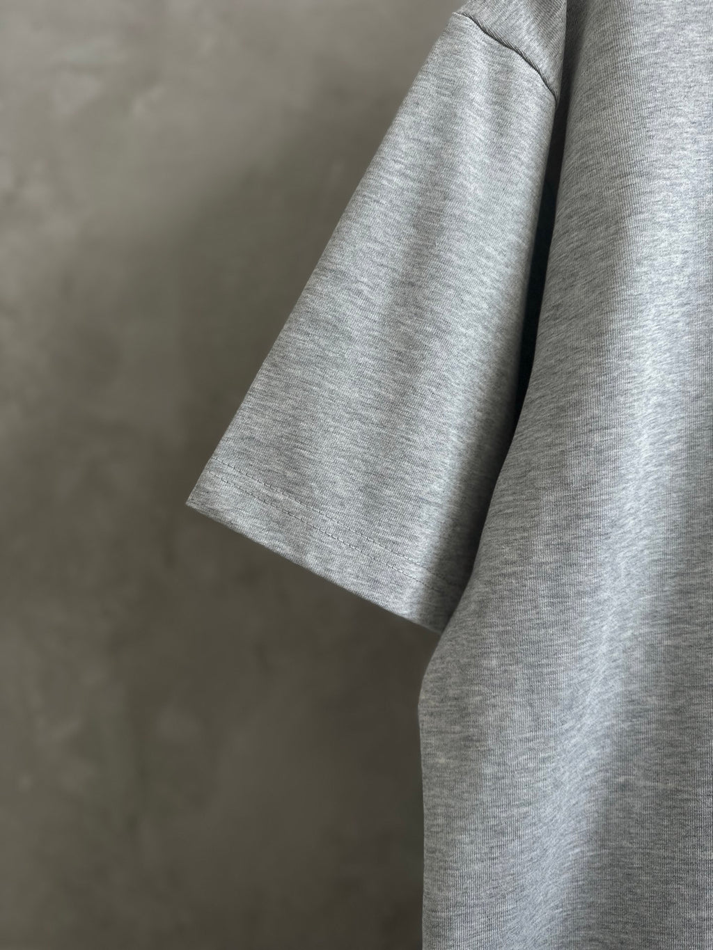 Gray T-shirt sleeve detail, short cuff and side seam