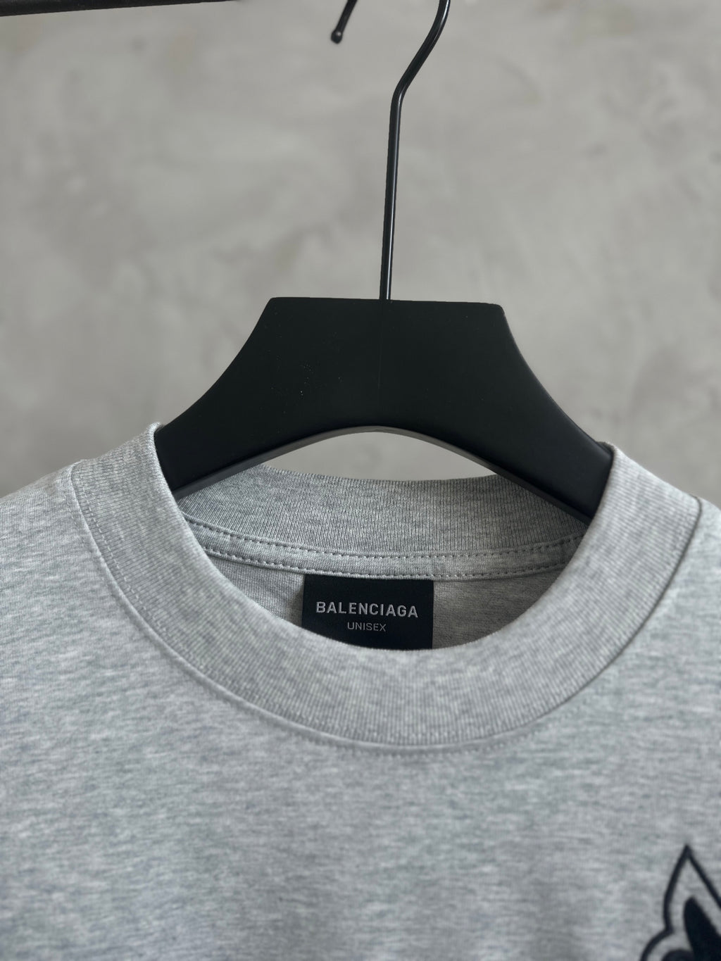 Gray T-shirt neckline with Balenciaga logo patch label inside collar