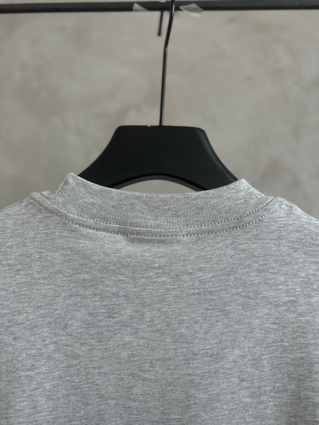Gray short-sleeve T-shirt neckline on hanger