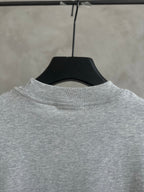 Gray short-sleeve T-shirt neckline on hanger