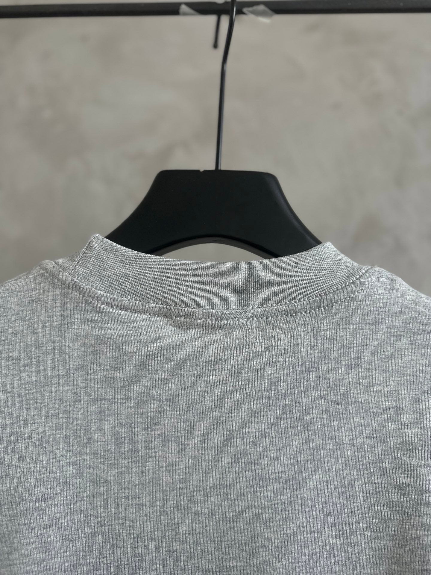 Gray short-sleeve T-shirt neckline on hanger