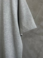 Gray T-shirt side view showing short sleeve and hem