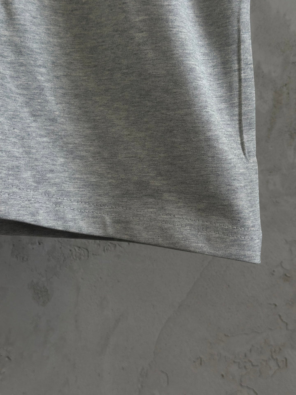 Gray T-shirt hem and side seam detail