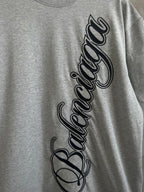 Gray T-shirt front close-up with Balenciaga script logo