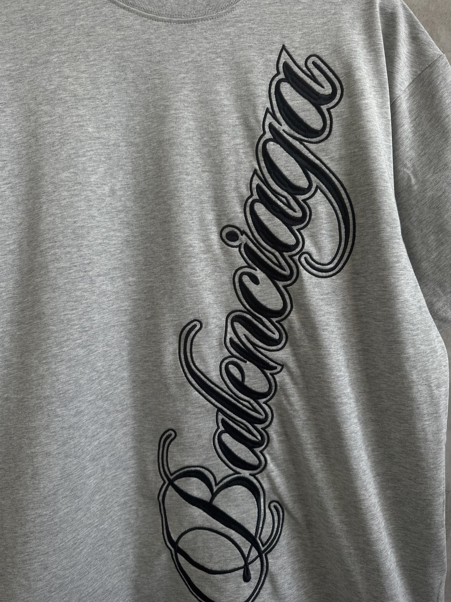 Gray T-shirt front close-up with Balenciaga script logo