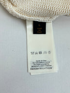 Cream knit sweater care label and size tag