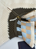 White knit sweater zipper with pearl trim and blue plaid accent panel
