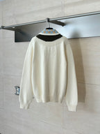 White knit sweater with striped collar and ribbed cuffs, viewed from the back