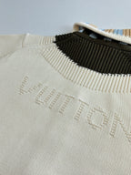 White knit sweater neckline with contrast black stripe and embossed LV logo