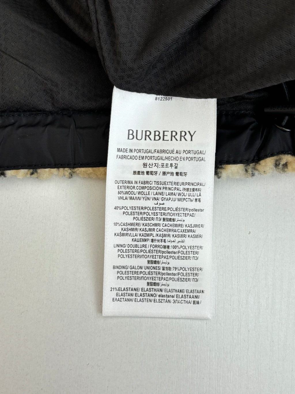 Burberry care label inside dark coat with stitched fabric and lining