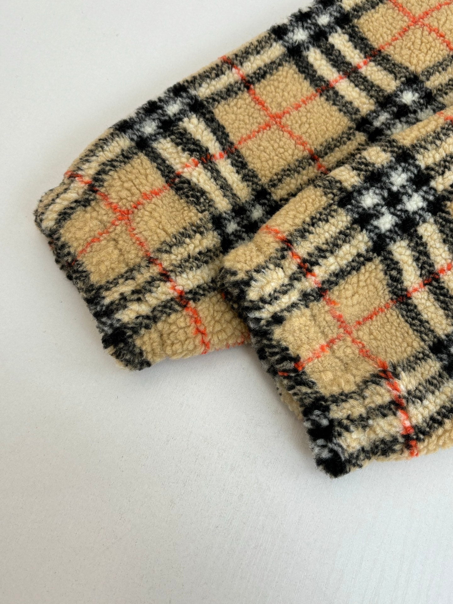 Plaid wool-blend long coat sleeve cuff with red and black grid pattern