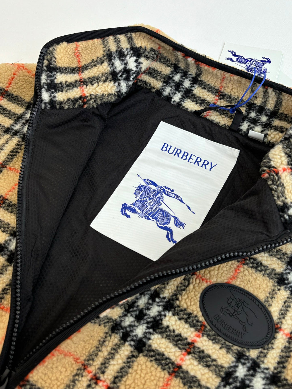 Burberry jacket interior lining with “BURBERRY” label and round logo patch