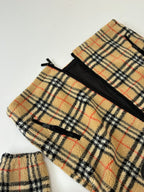 Plaid jacket front with black zipper tape and open hem view