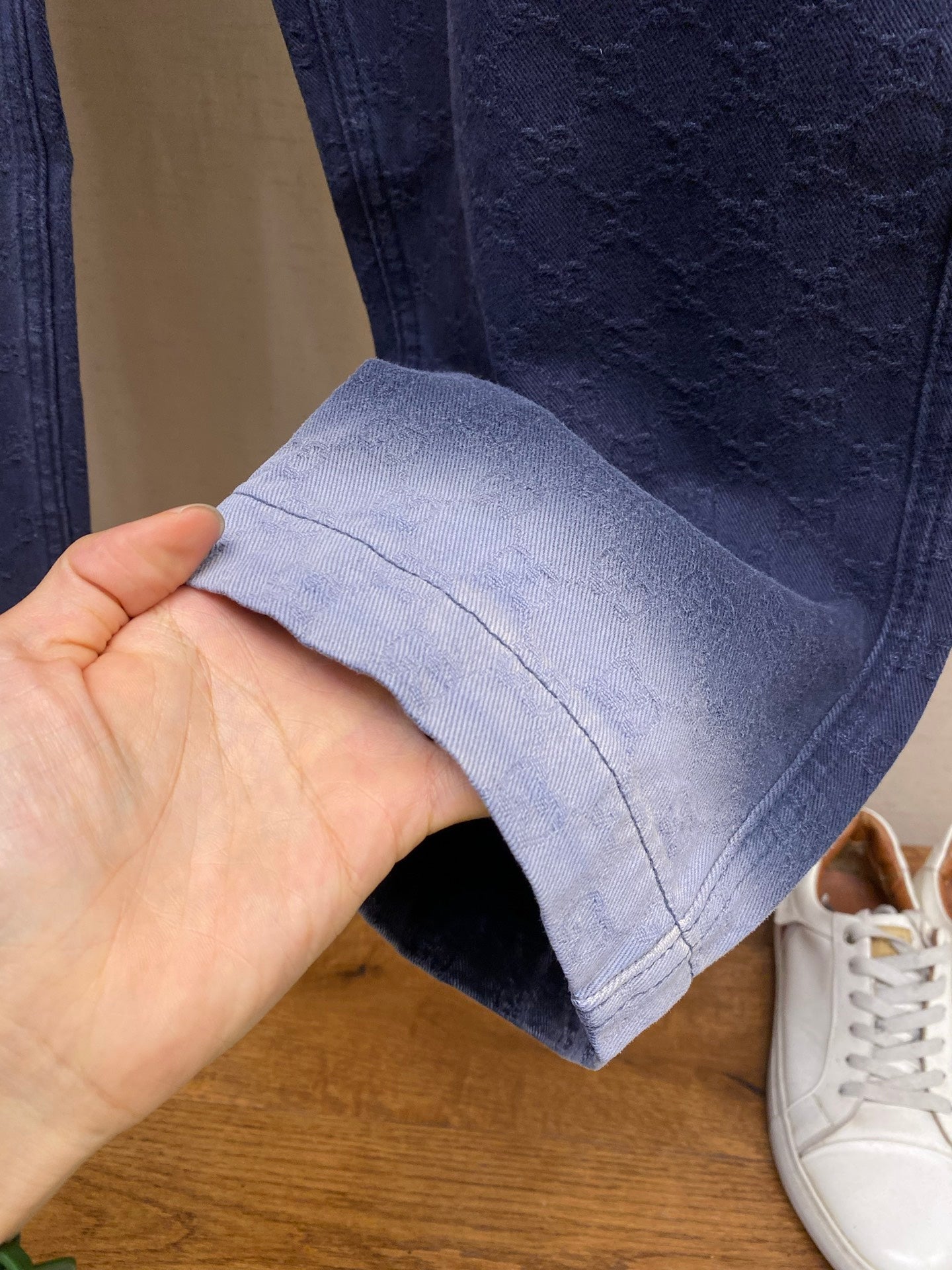 Gucci pants hem close-up, navy fabric with stitched cuff