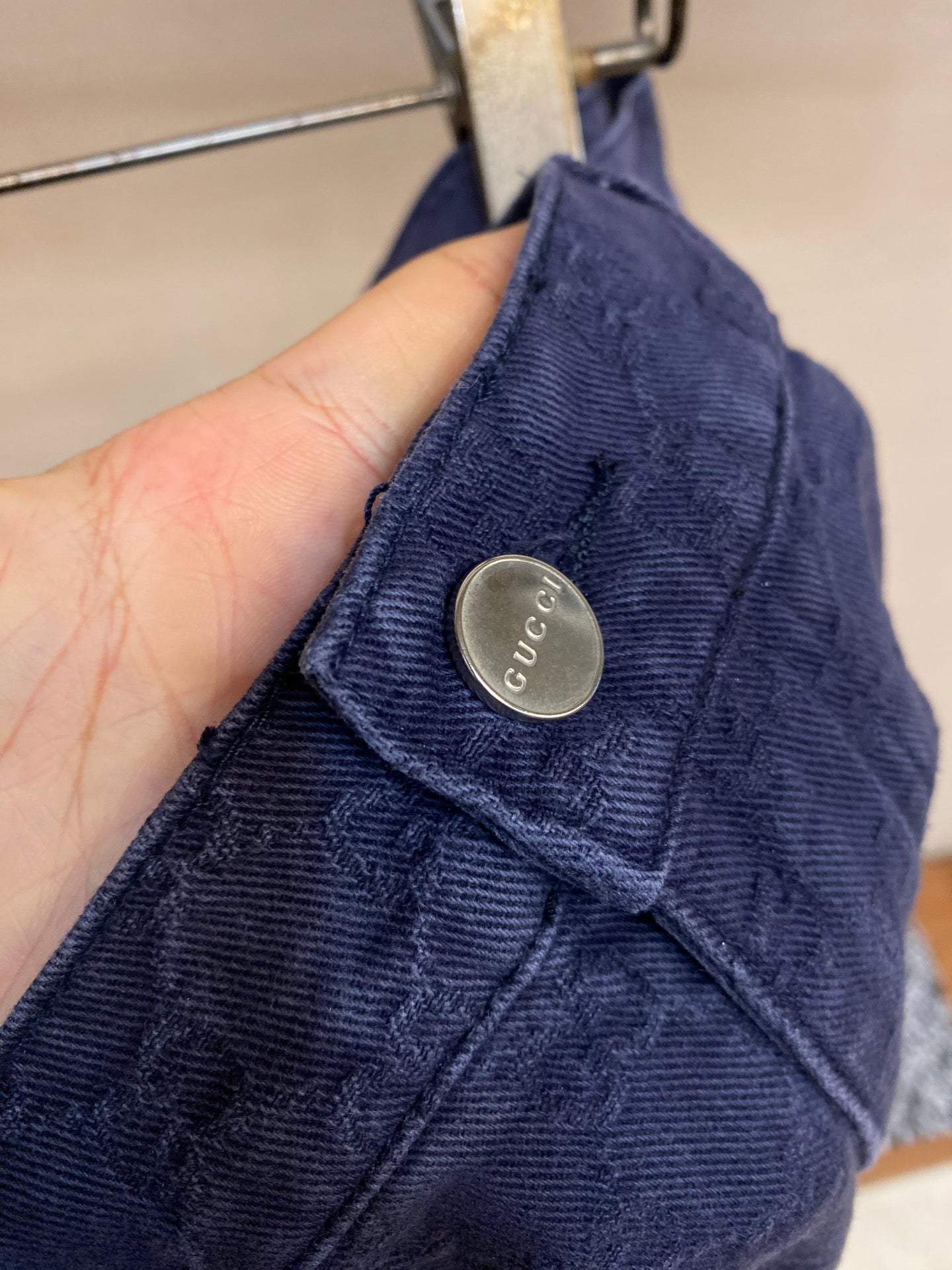 Gucci pants waistband detail, Gucci logo metal button and belt loops