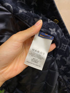 Care label and blue brand tag on navy Louis Vuitton quilted jacket lining