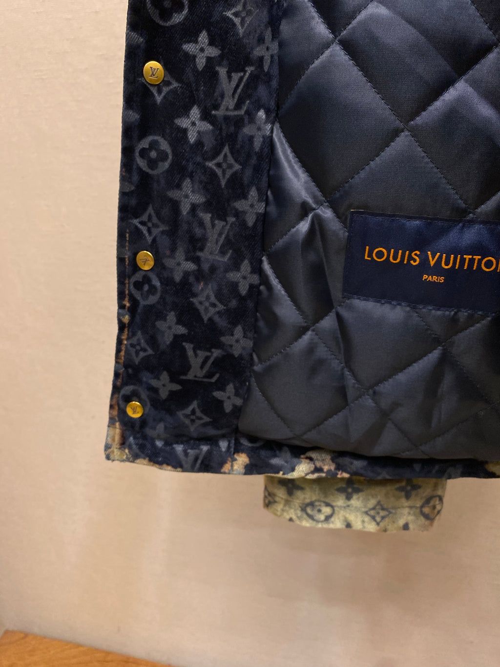 Louis Vuitton quilted lining panel on navy monogram jacket with gold buttons