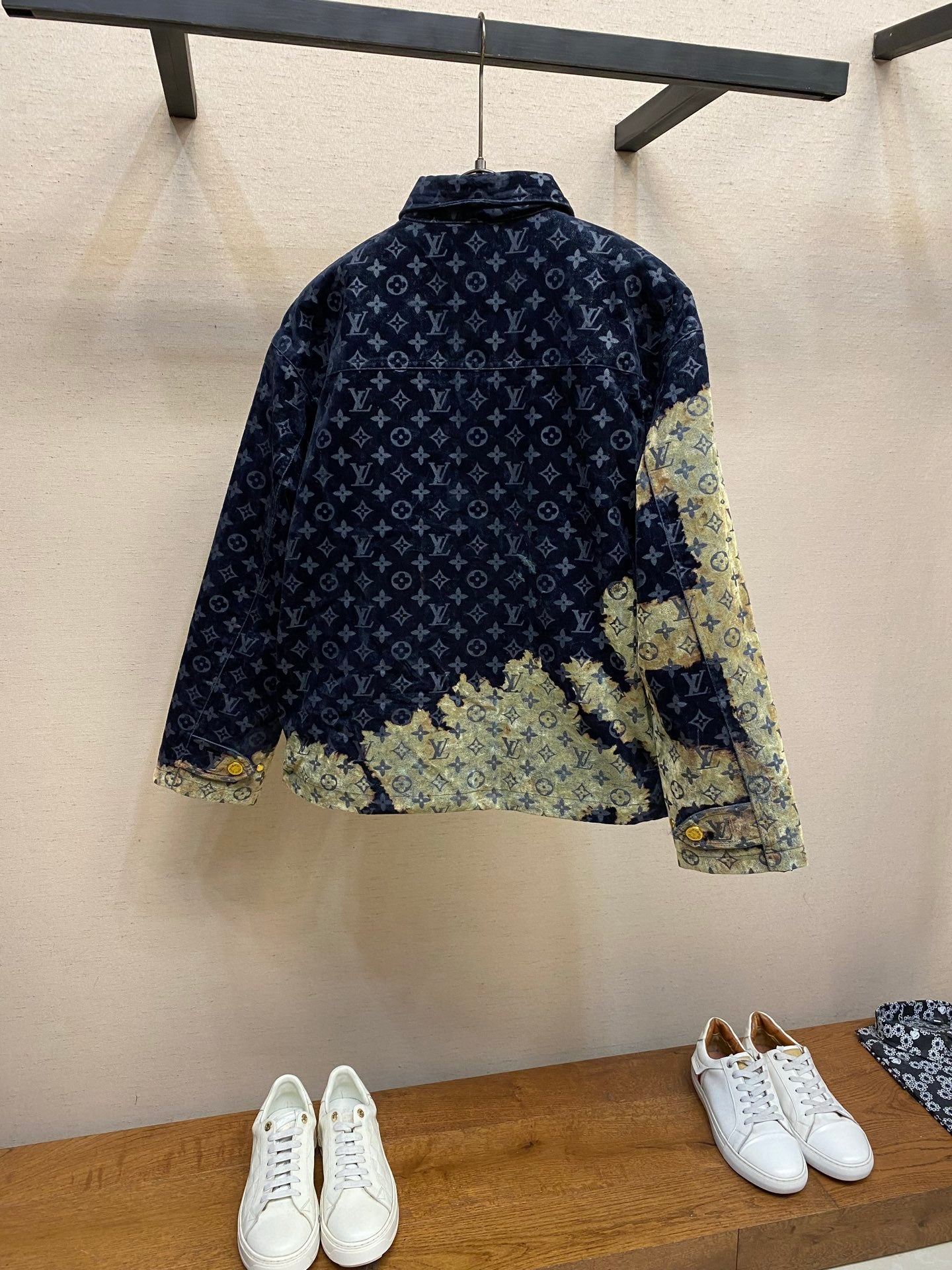 Back of Louis Vuitton monogram jacket with light green patchwork hem and gold buttons