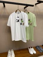 White and light green Dior graphic T-shirts on hangers, crew neck and chest logos