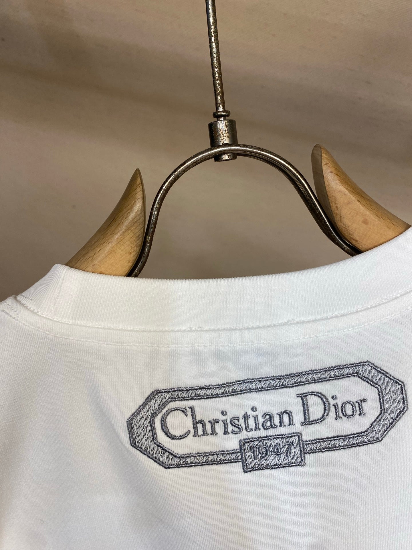 White T-shirt neckline with Christian Dior logo patch
