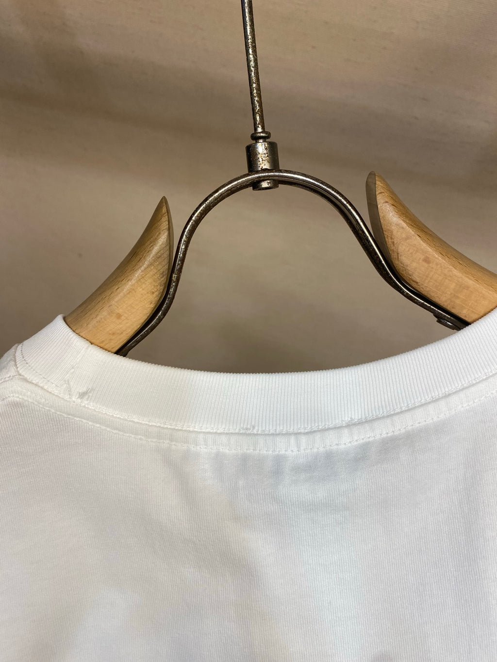 White Christian Dior T-shirt crew neck close-up on hanger