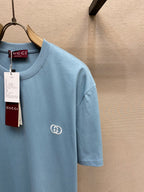 Light blue Gucci crew-neck T-shirt side view with chest logo and tag