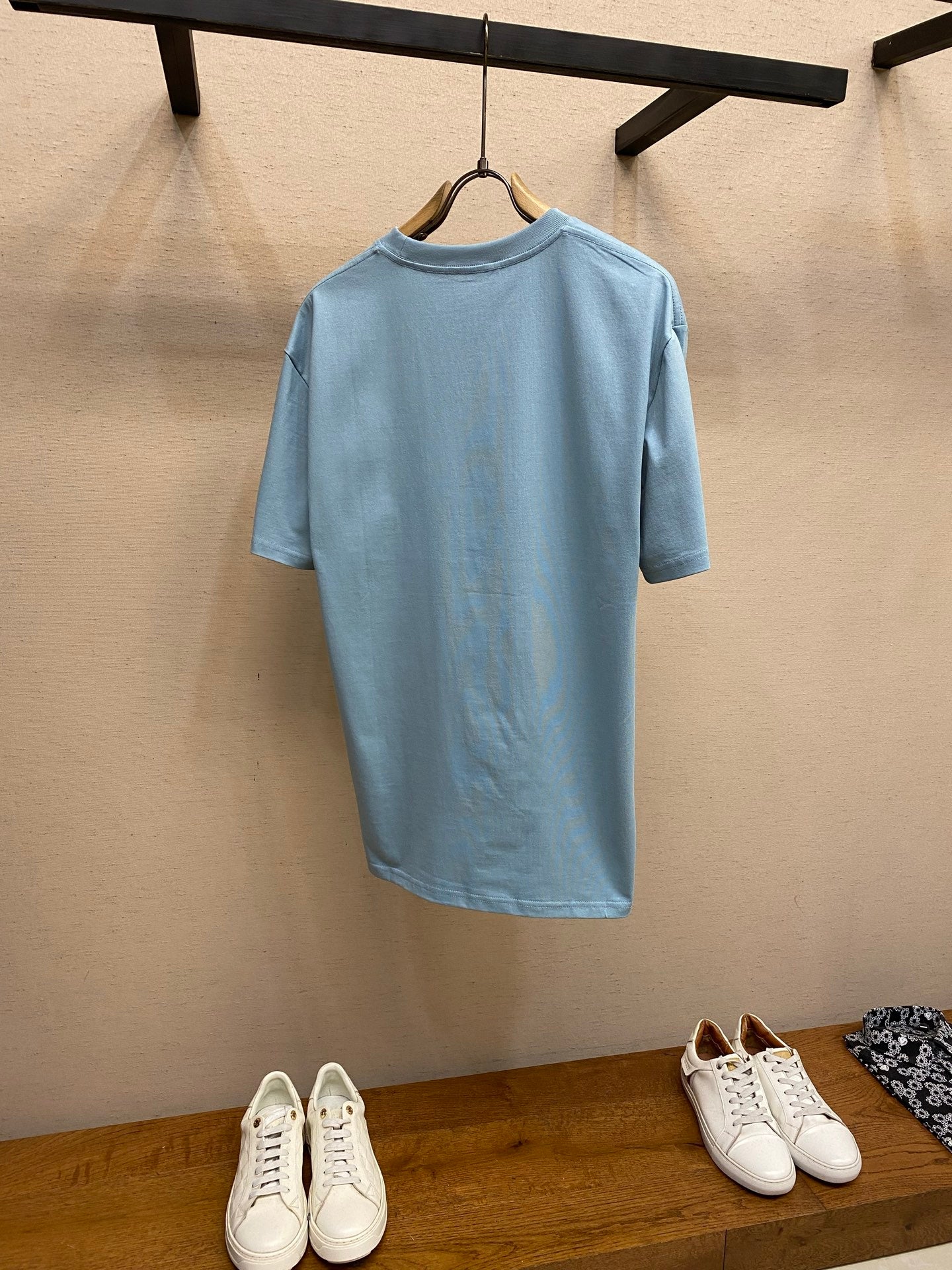 Light blue Gucci crew-neck T-shirt back view with hanging tag