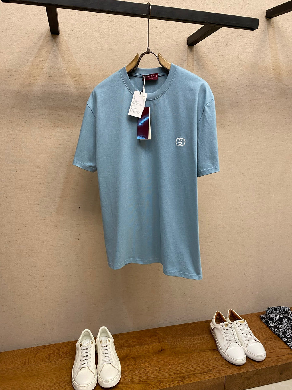 Light blue Gucci crew-neck T-shirt with small chest logo and hanging tag