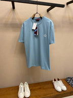 Light blue Gucci crew-neck T-shirt with small chest logo and hanging tag