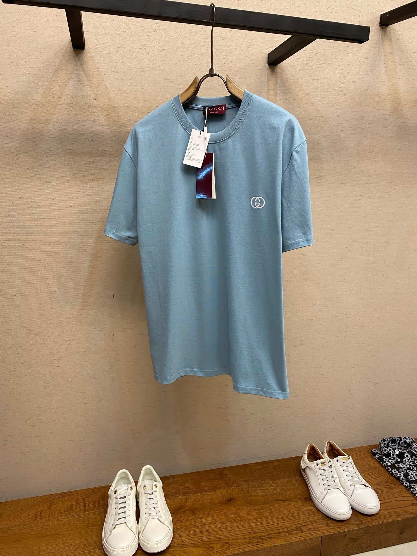 Light blue Gucci crew-neck T-shirt with small chest logo and hanging tag
