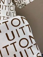 Louis Vuitton monogram T-shirt sleeve detail, white with brown repeating letters
