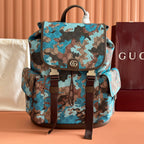 Gucci canvas backpack with blue-brown camo print, front flap pocket, and brown leather trim