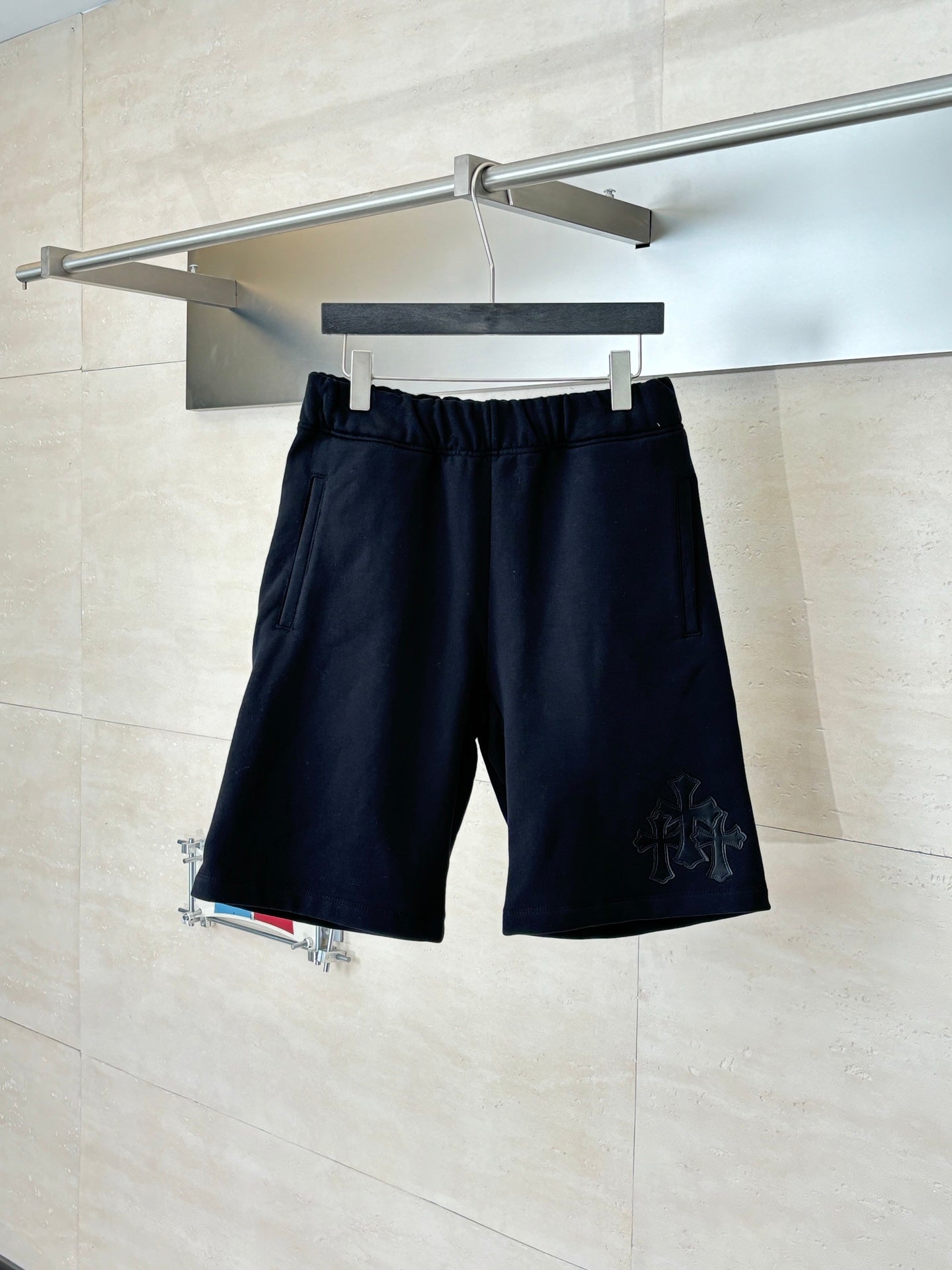 Navy drawstring shorts with elastic waistband and small embroidered side logo