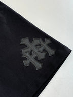 Black shorts with large embroidered cross-style side patch