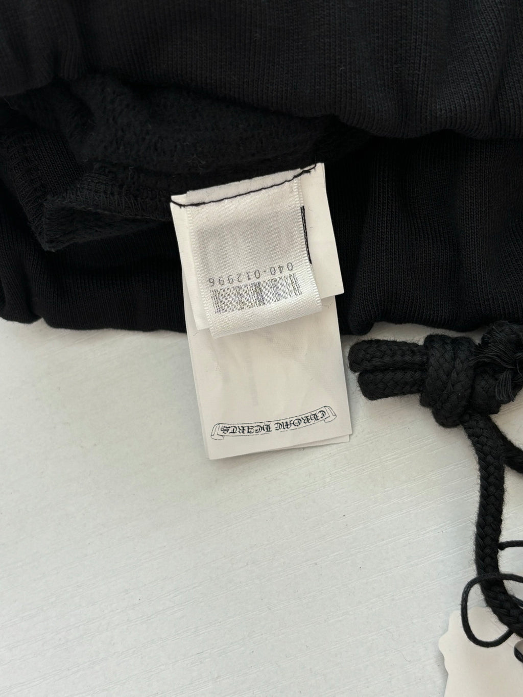 Black shorts with inner size label and drawstring knot detail
