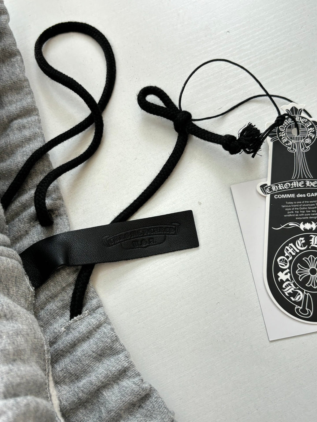 Heather gray shorts with black drawcords and hanging brand swing tags