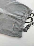 Heather gray shorts with drawstring, side pocket, and woven label at hem