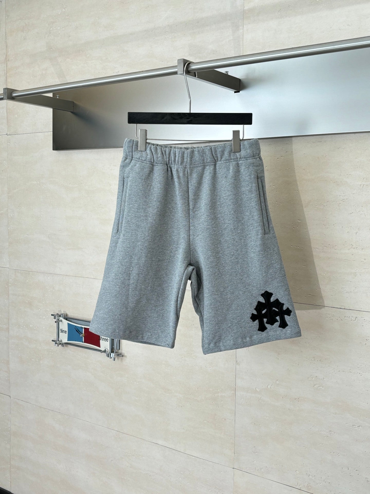 Heather gray shorts with drawstring waistband and black logo graphic on leg