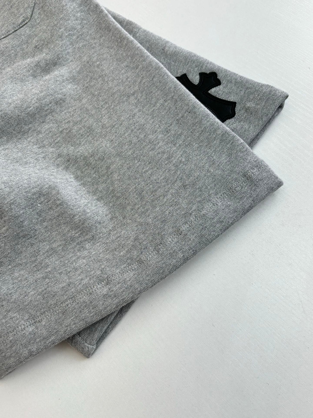 Heather gray shorts with cuffed hem and small black logo patch