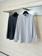 Pair of long-sleeve crewneck tops, light and dark gray, with graphic sleeve stripe