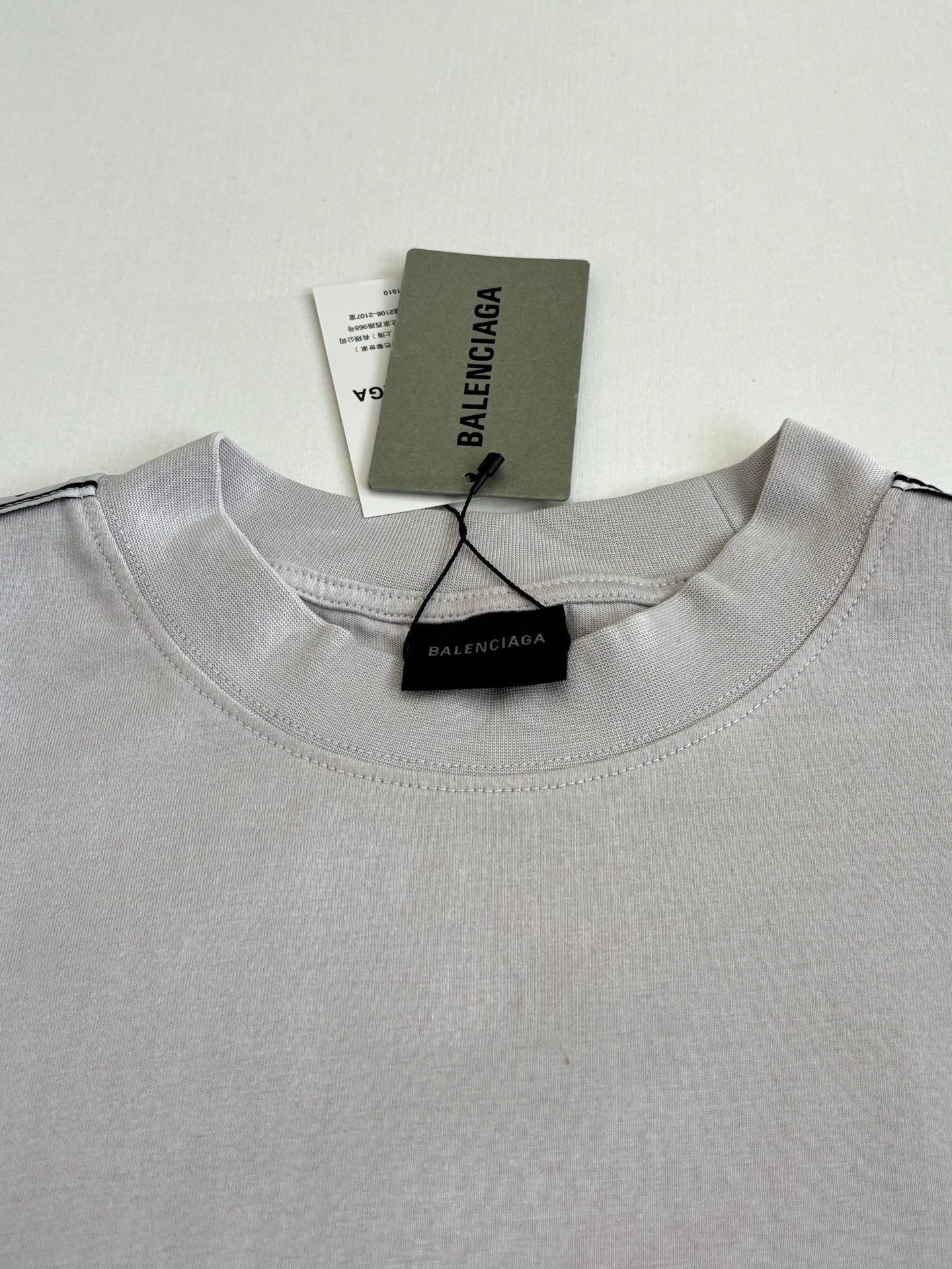 Light gray crewneck top with BALENCIAGA logo neck label