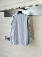 Light gray long-sleeve crewneck top with black logo trim on sleeves, back view