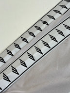 Light gray sleeve panel with repeating black logo graphics